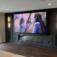 115-inch TV with in-wall speakers and linear fireplace in a Lakeville, MN home media room installed by Signal AV