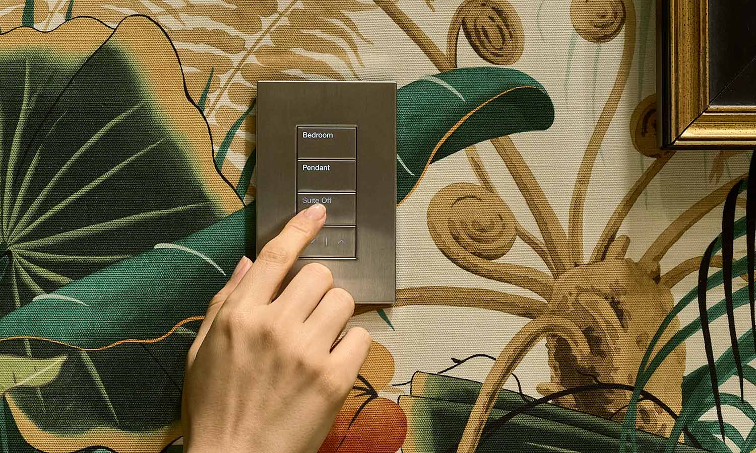 Hand pressing a wall keypad mounted on patterned wallpaper