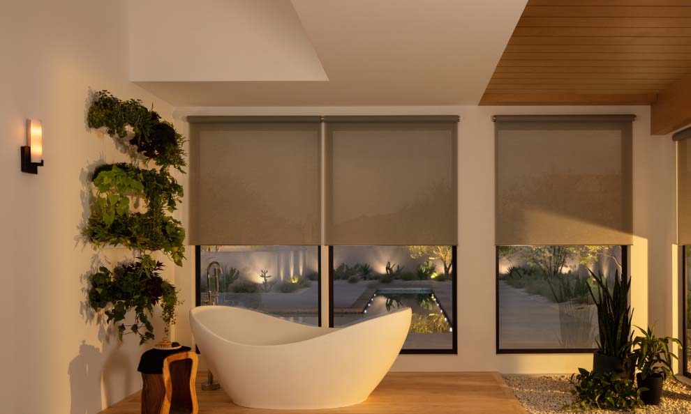Modern bathroom with bathtub and automated window shades