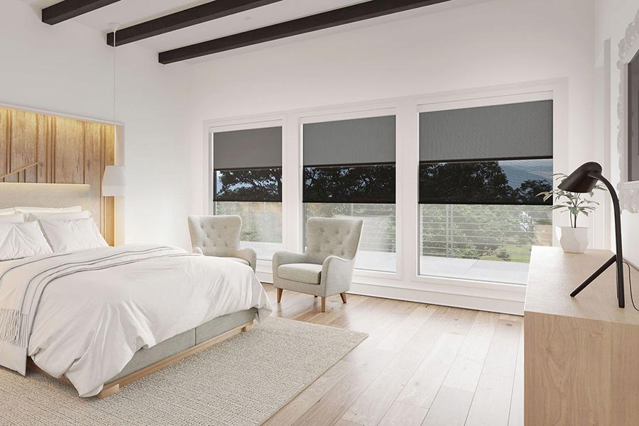 Modern bedroom with large windows featuring automated blackout shades
