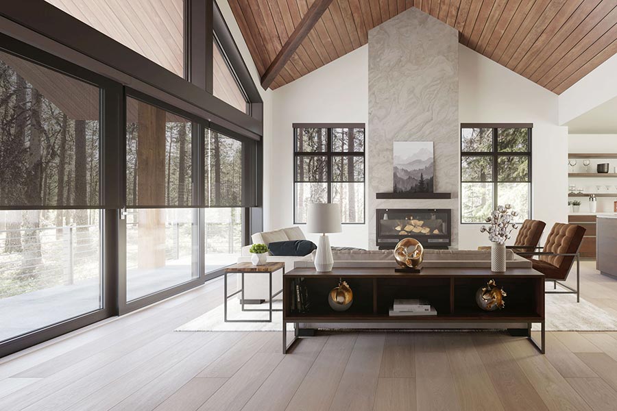 Living room with vaulted ceiling, fireplace, and floor-to-ceiling windows with shades
