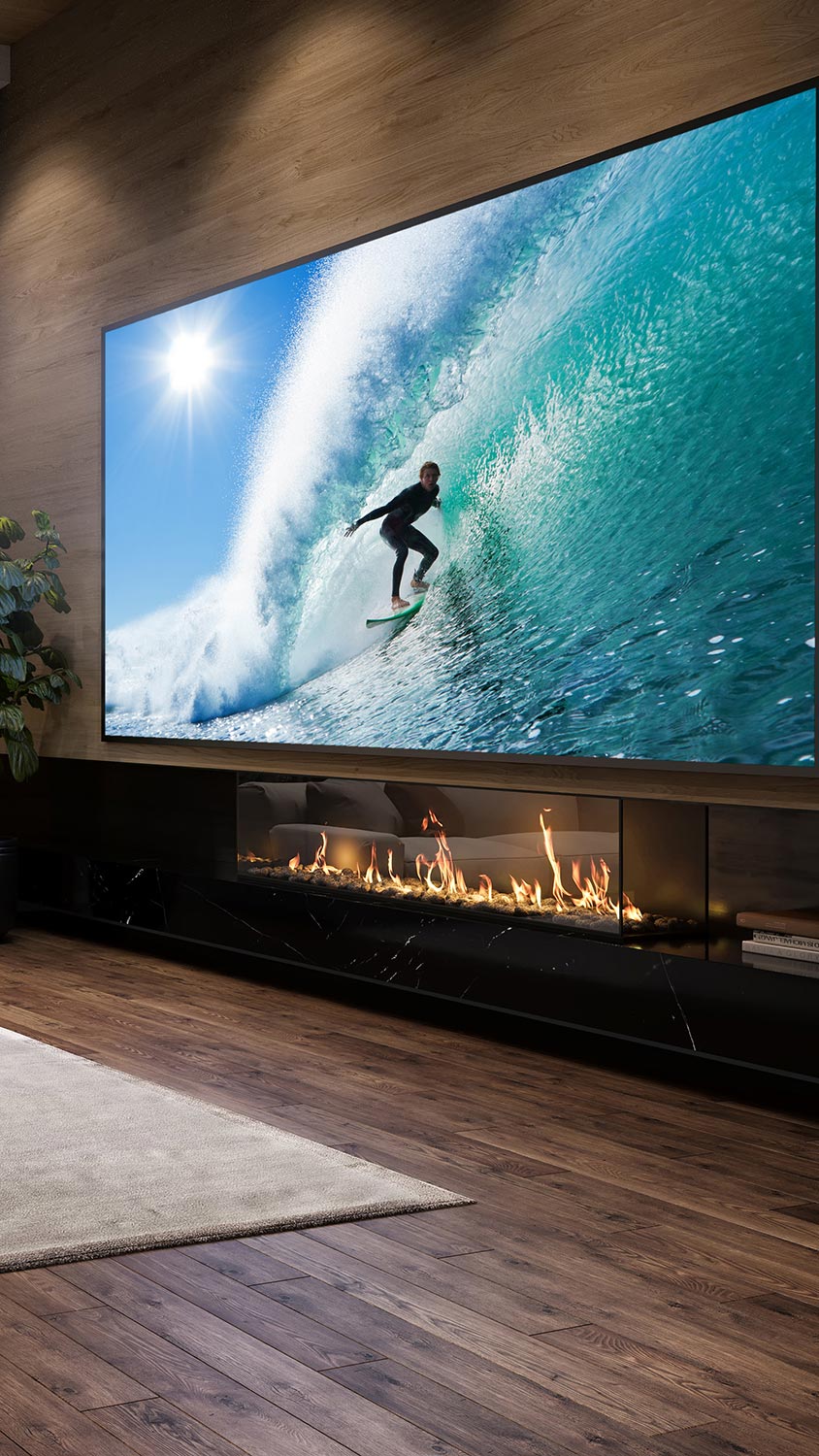 Large flat-screen TV above modern fireplace showing surfer riding wave