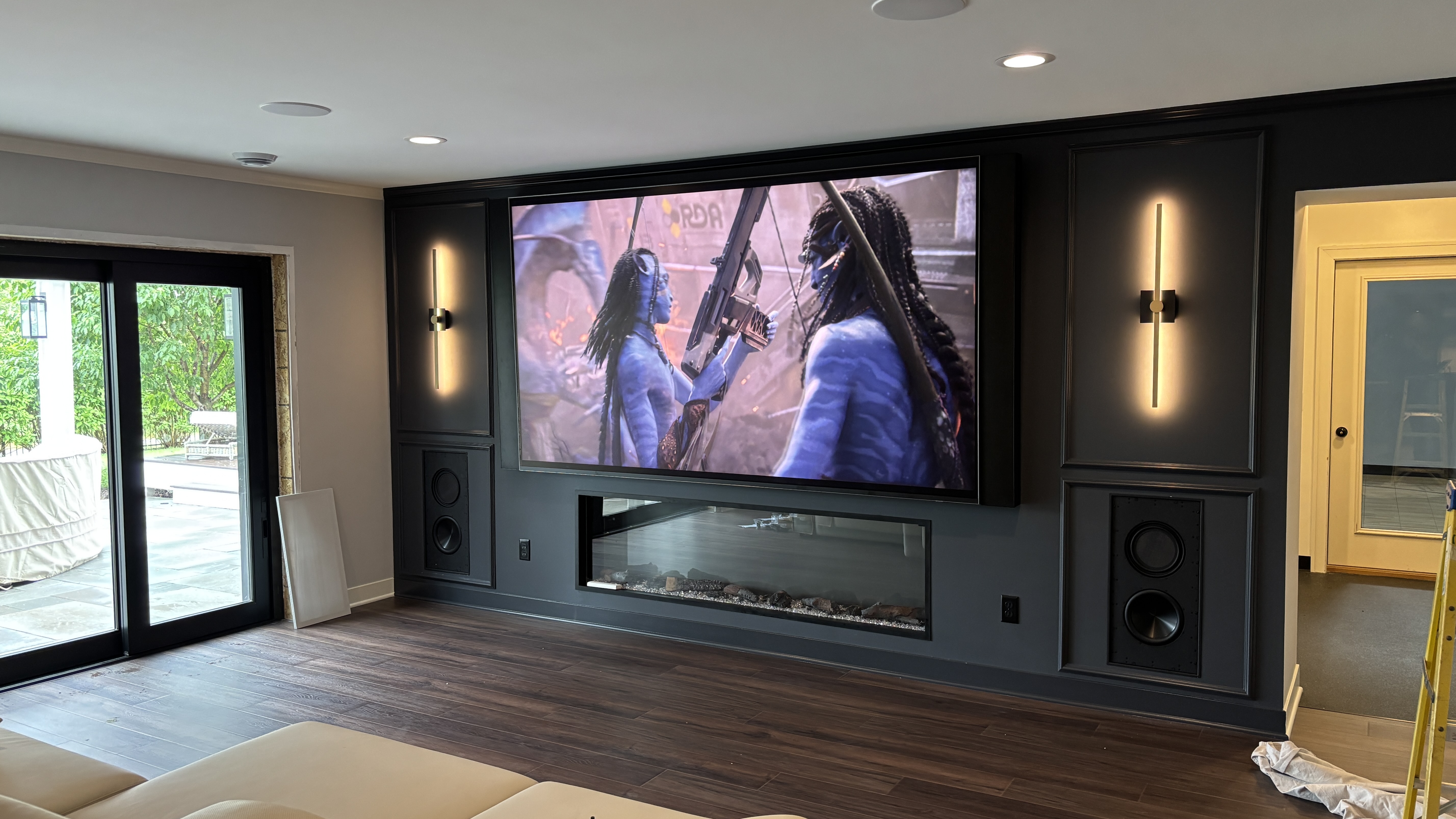115-inch TV with in-wall speakers and linear fireplace in a Lakeville, MN home media room installed by Signal AV