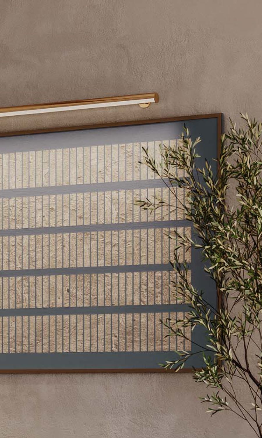 Wall art illuminated by a slim picture light beside a potted tree