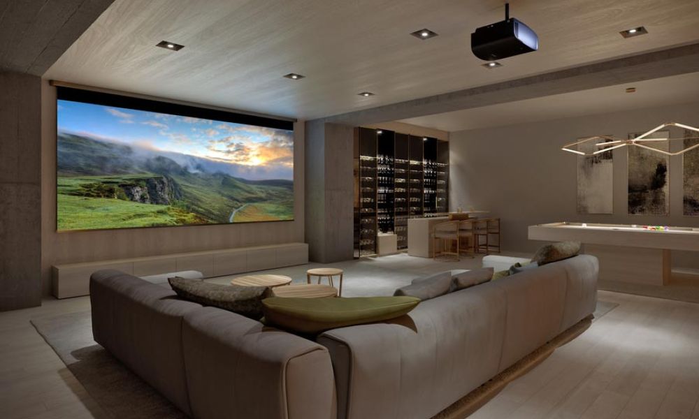 <span class="uk-h4">A casual home theater with a large screen, Sony projector, wine bar, pool table, and sectional.</span>