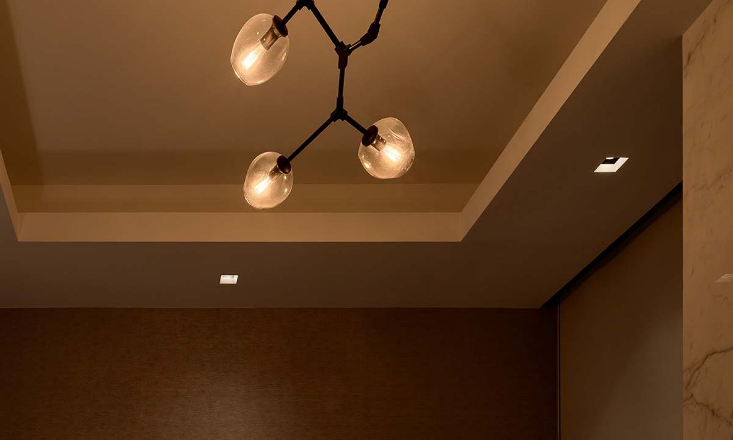 Modern ceiling light fixture with soft dimmed lighting in warm tones