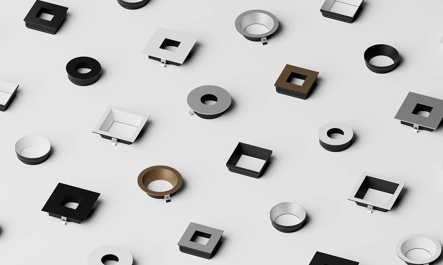 Assorted modern recessed lighting trims in various shapes and colors on white background